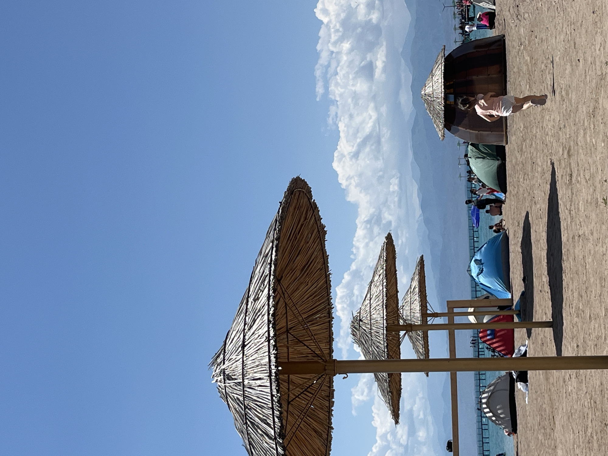 Sunny day at Balykchy's thatched-umbrella beach on Issyk-Kul