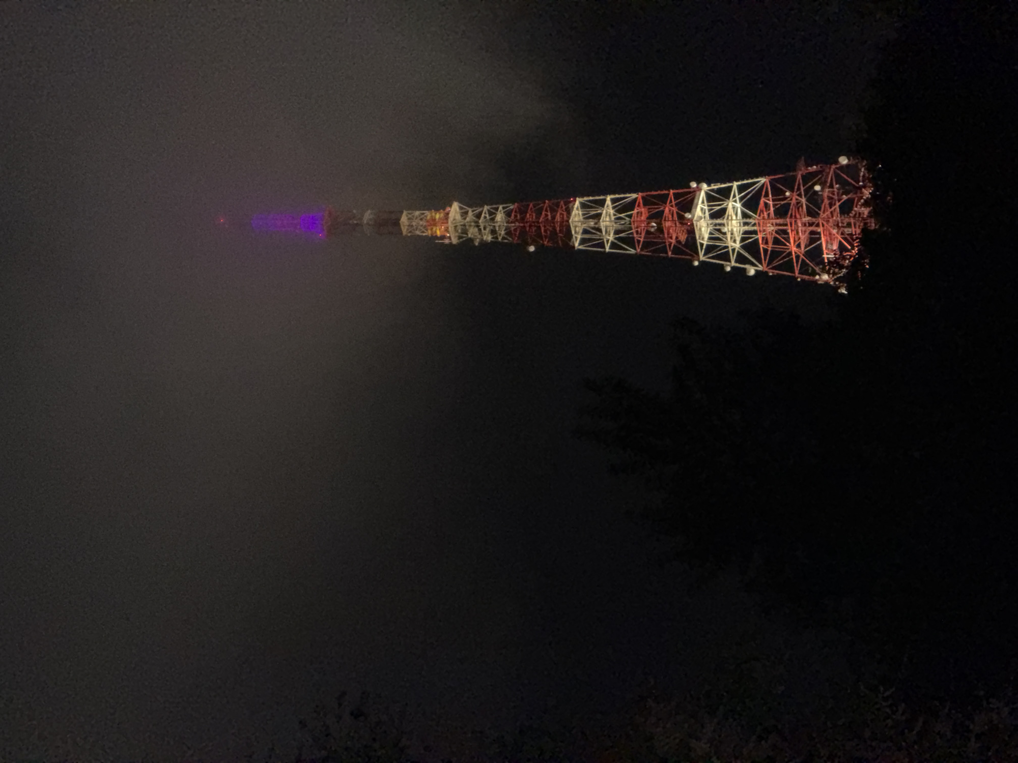 Foggy night illuminates telecommunications tower in Birobidzhan, Russia