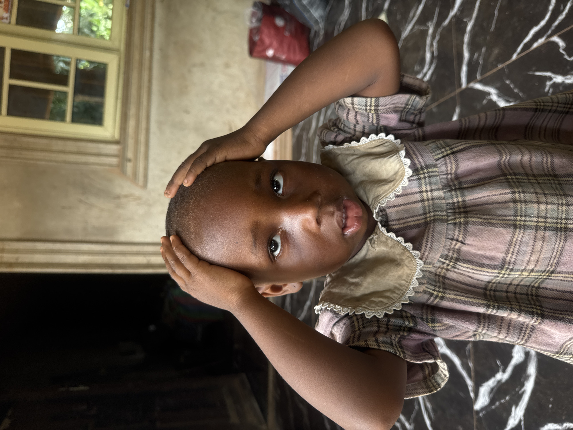 Children photographed in indoor setting in Eziudo, Nigeria