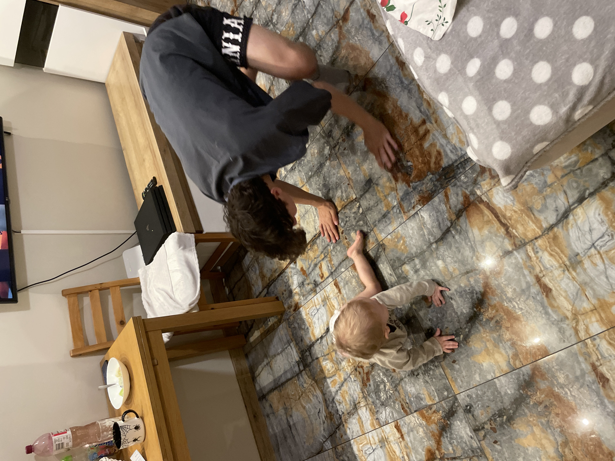 Children crawling and playing indoors in family setting