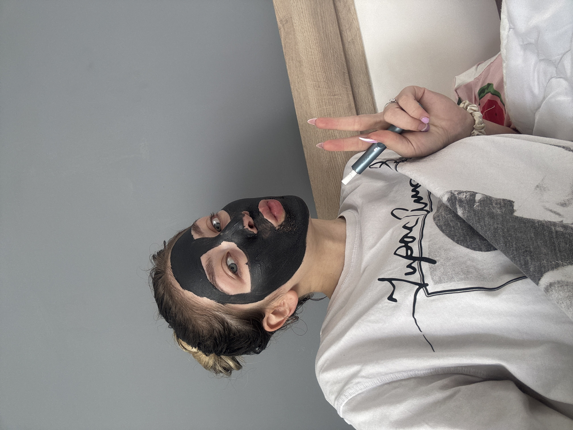 Person applies facial mask treatment indoors in Yambol