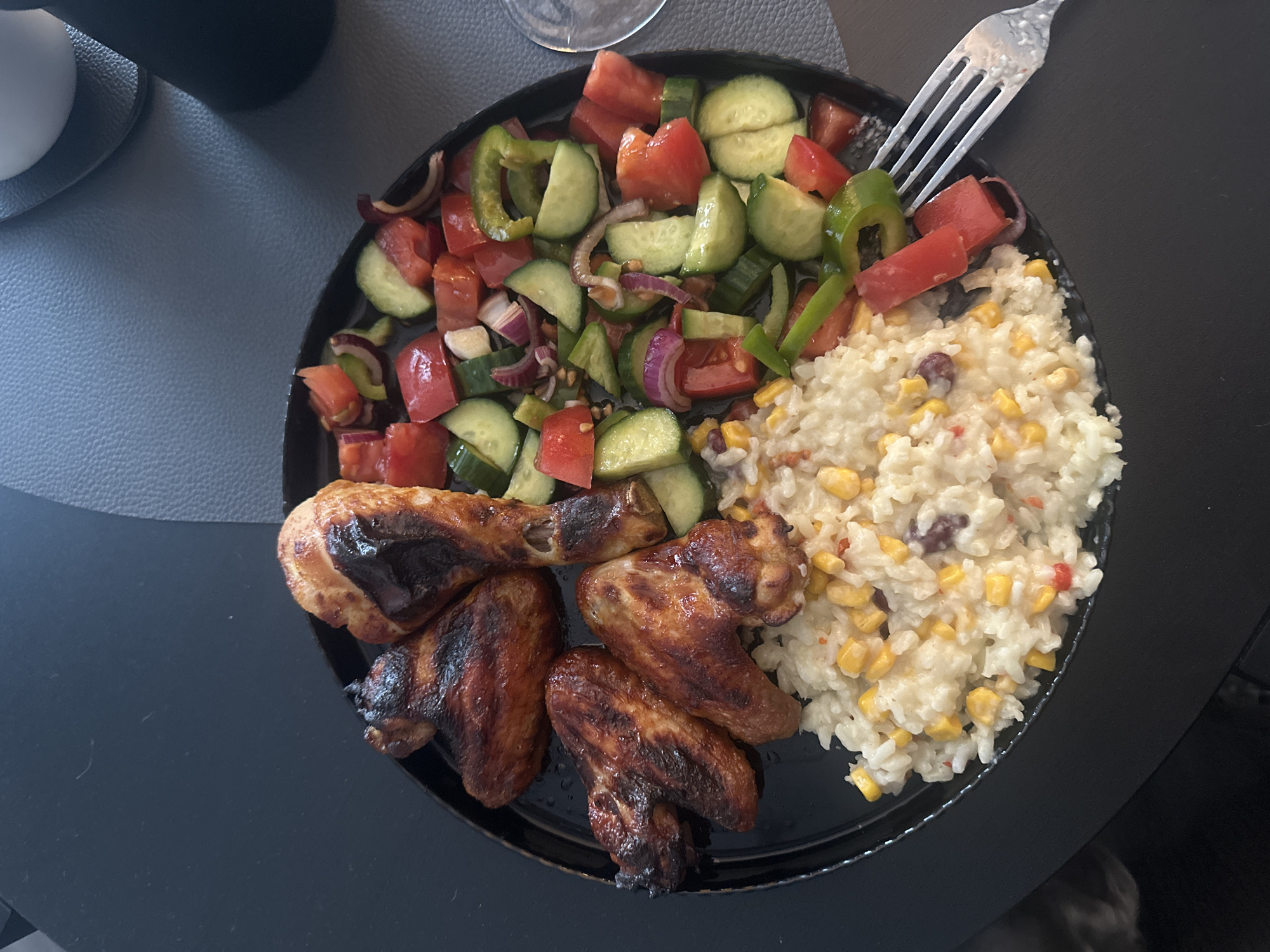Grilled chicken and rice served on a black plate in Burgas