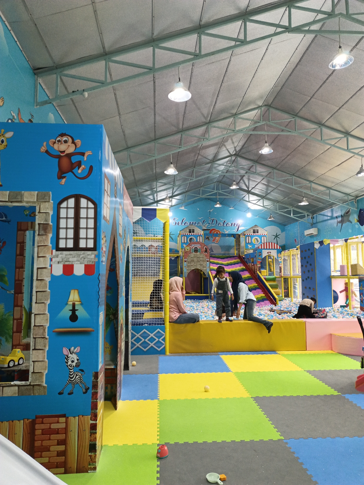 Children play at indoor playground facility in Cotbadatunong