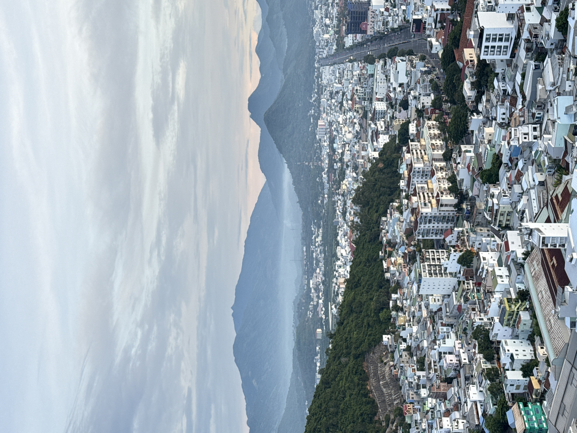 Dusk aerial survey of Nha Trang's coastline and city grid