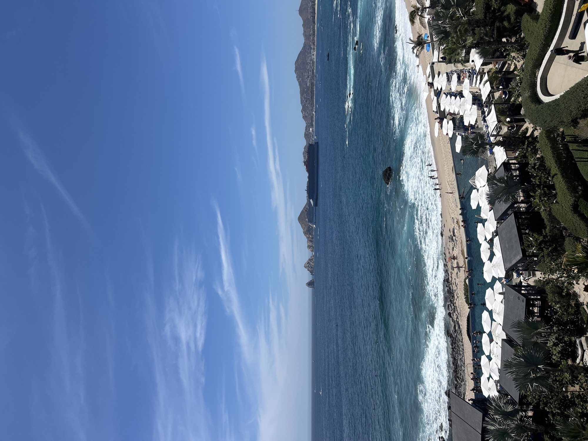 Aerial views capture Cabo San Lucas coastline under clear skies