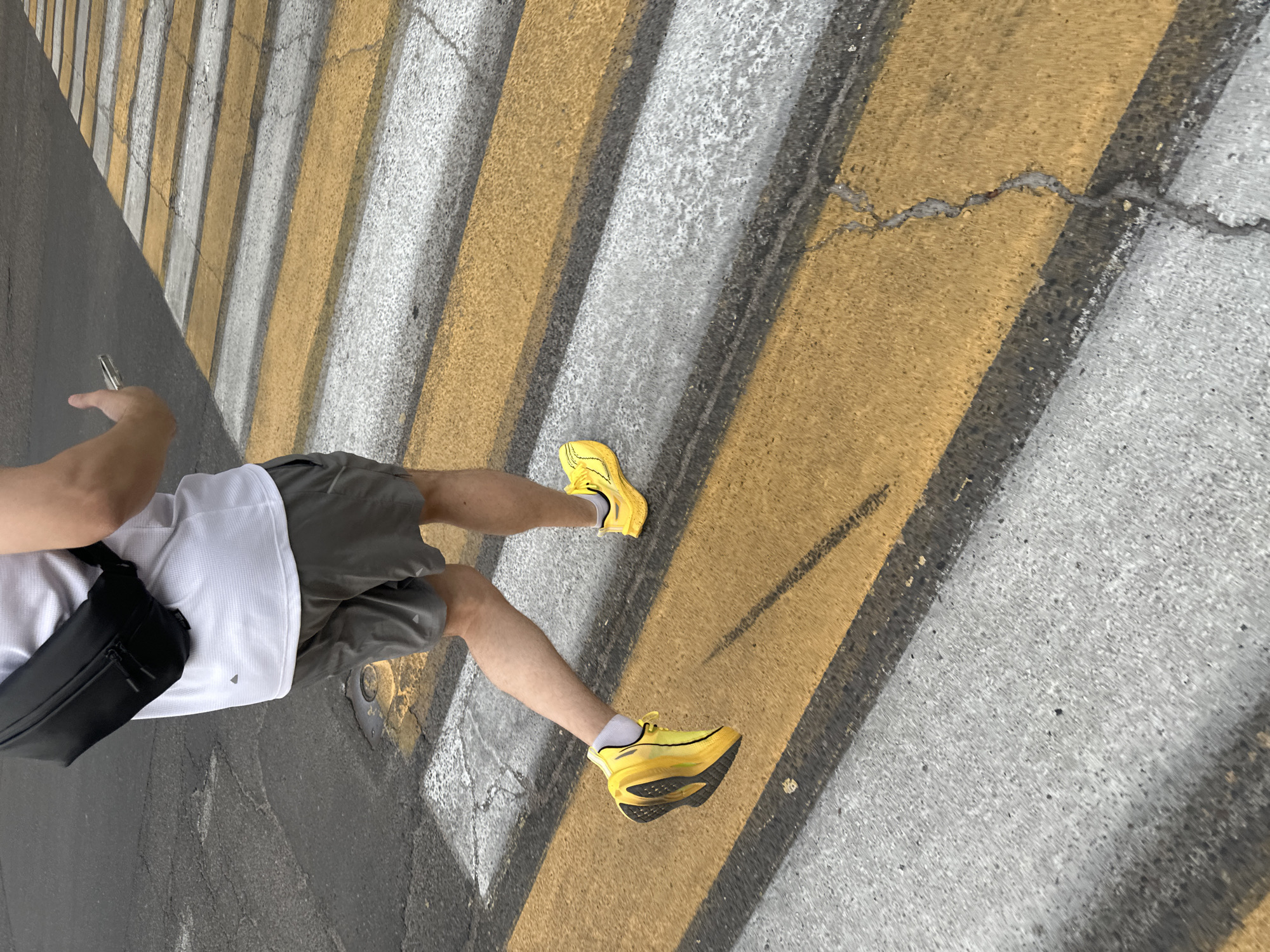 Man in athletic wear stands on crosswalk in Tashkent