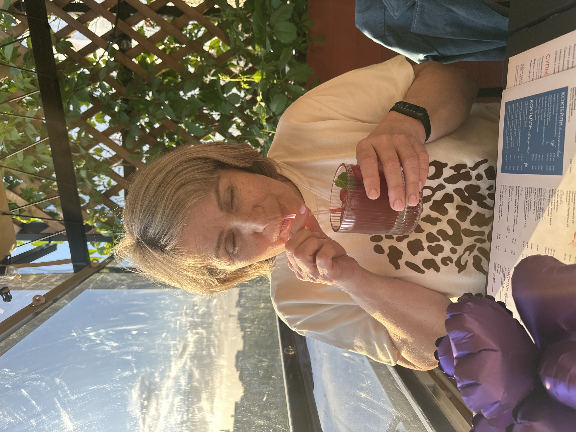 Family enjoys outdoor dining with cocktails and balloons in Perm