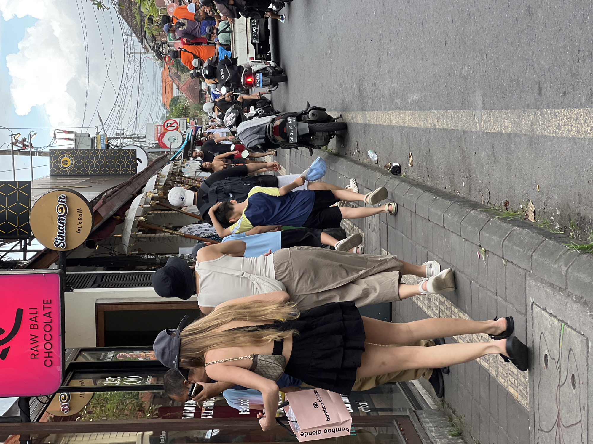 Tourist documents morning journey through Ubud's streets and temples