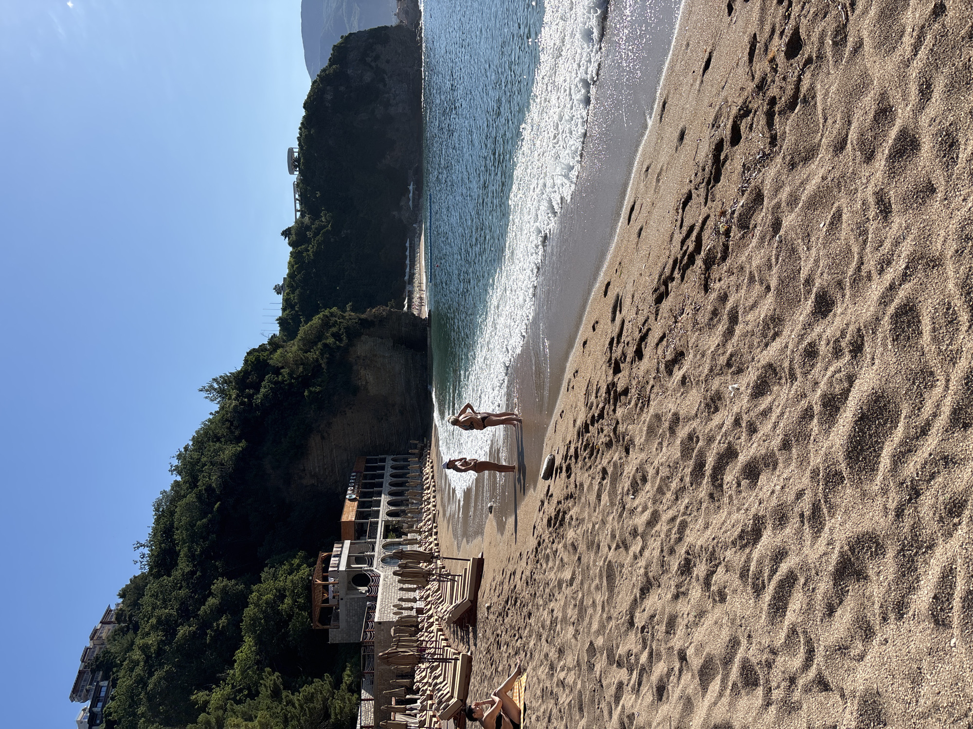 Calm beach morning, empty chairs and rolling waves
