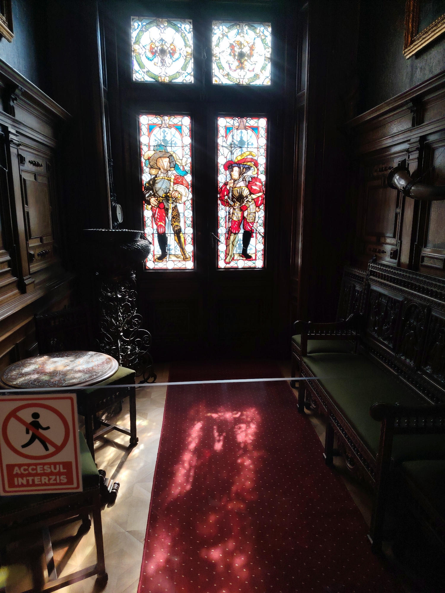 Visitor documents ornate interiors at Peleș Castle, Romania