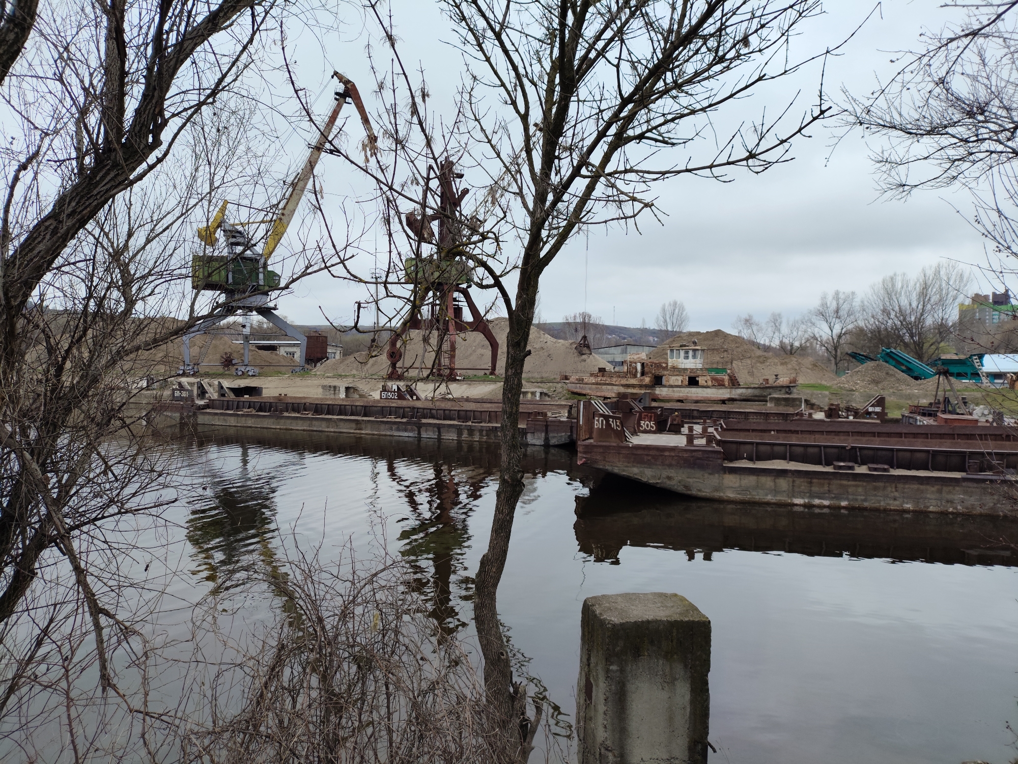 Derelict barges line industrial riverbank in Rybnitsa, Moldova
