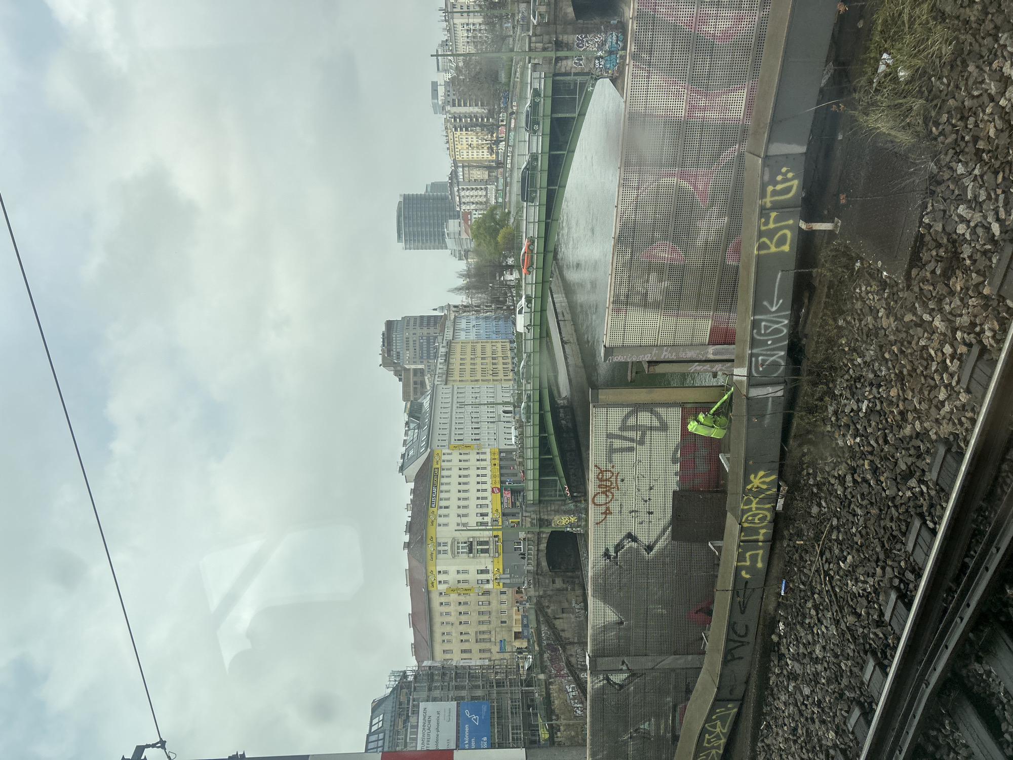 Train passenger views Vienna railway infrastructure with graffiti