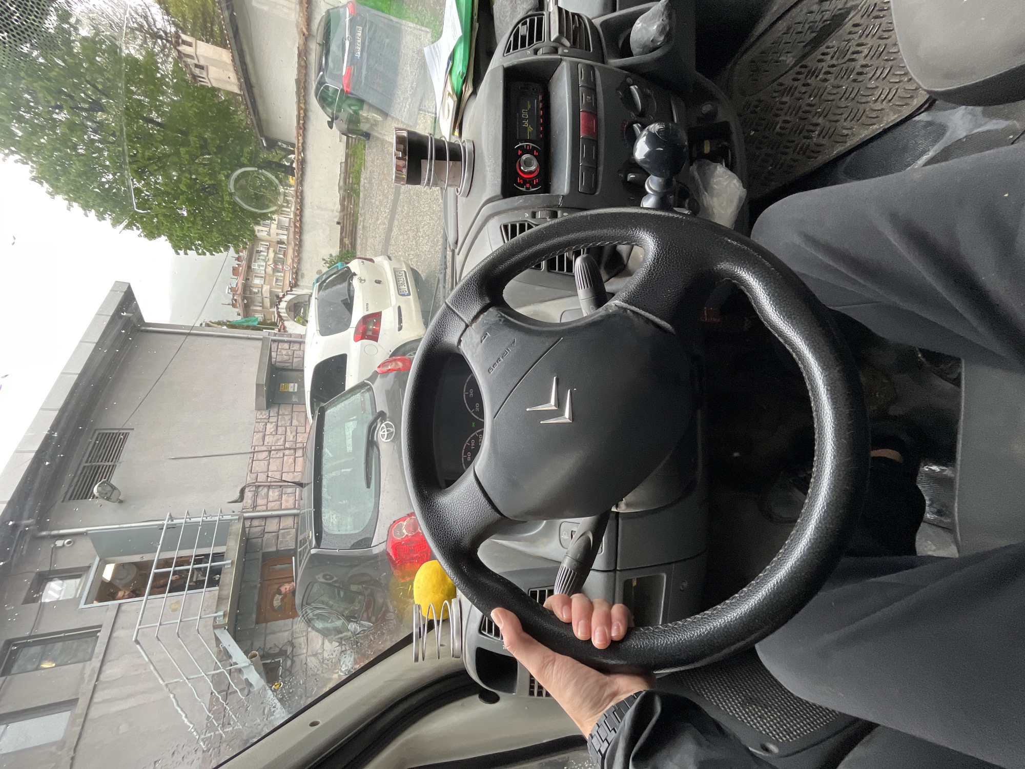 Driver documents rainy journey through Karlovo, Bulgaria streets