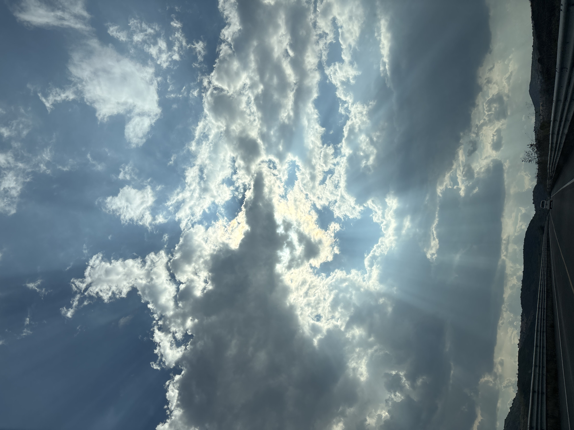Sunlight breaks through clouds over Santiago Atzitzihuacán, Mexico