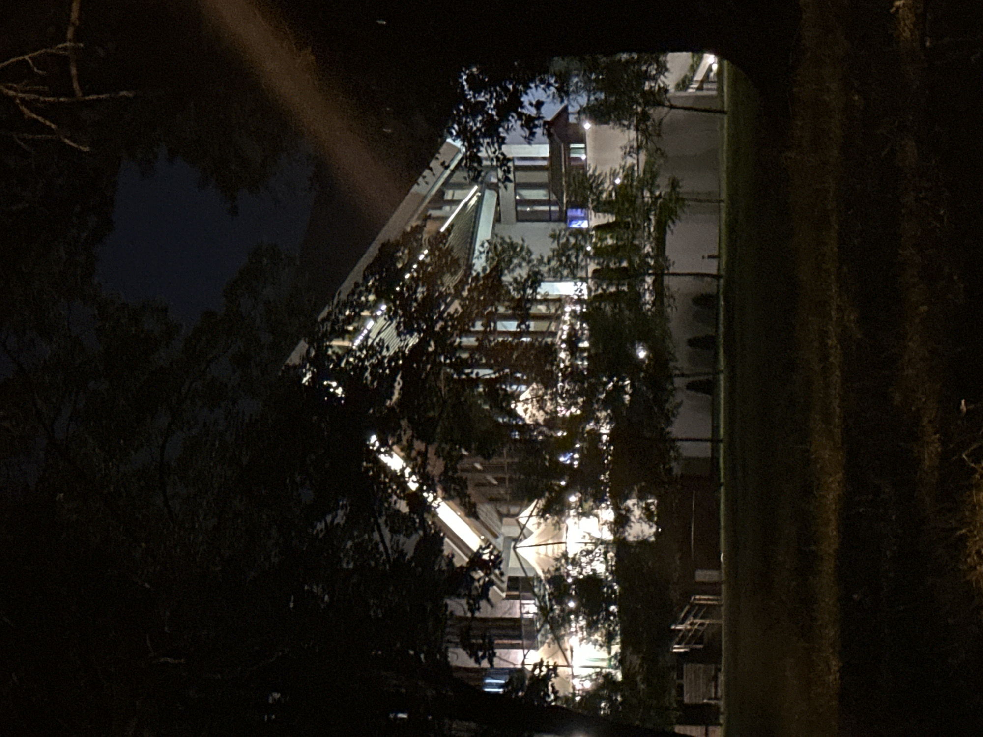 Evening stroll around a lit waterfront park and modern building