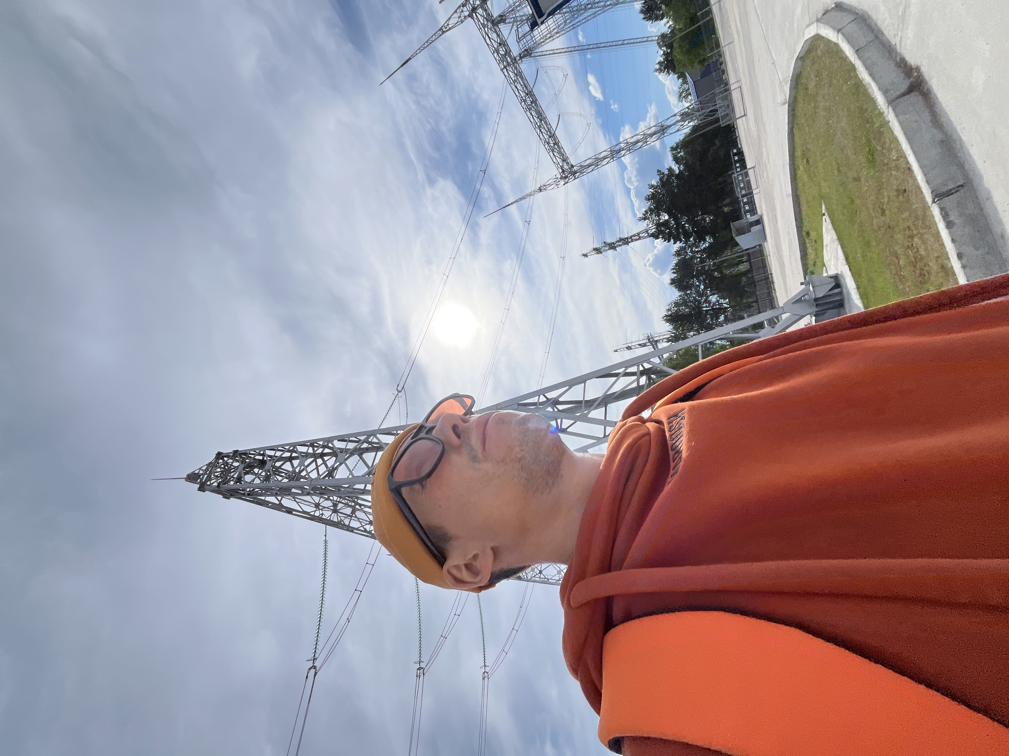Man gazes at power lines under cloudy sky in Chaikovsky