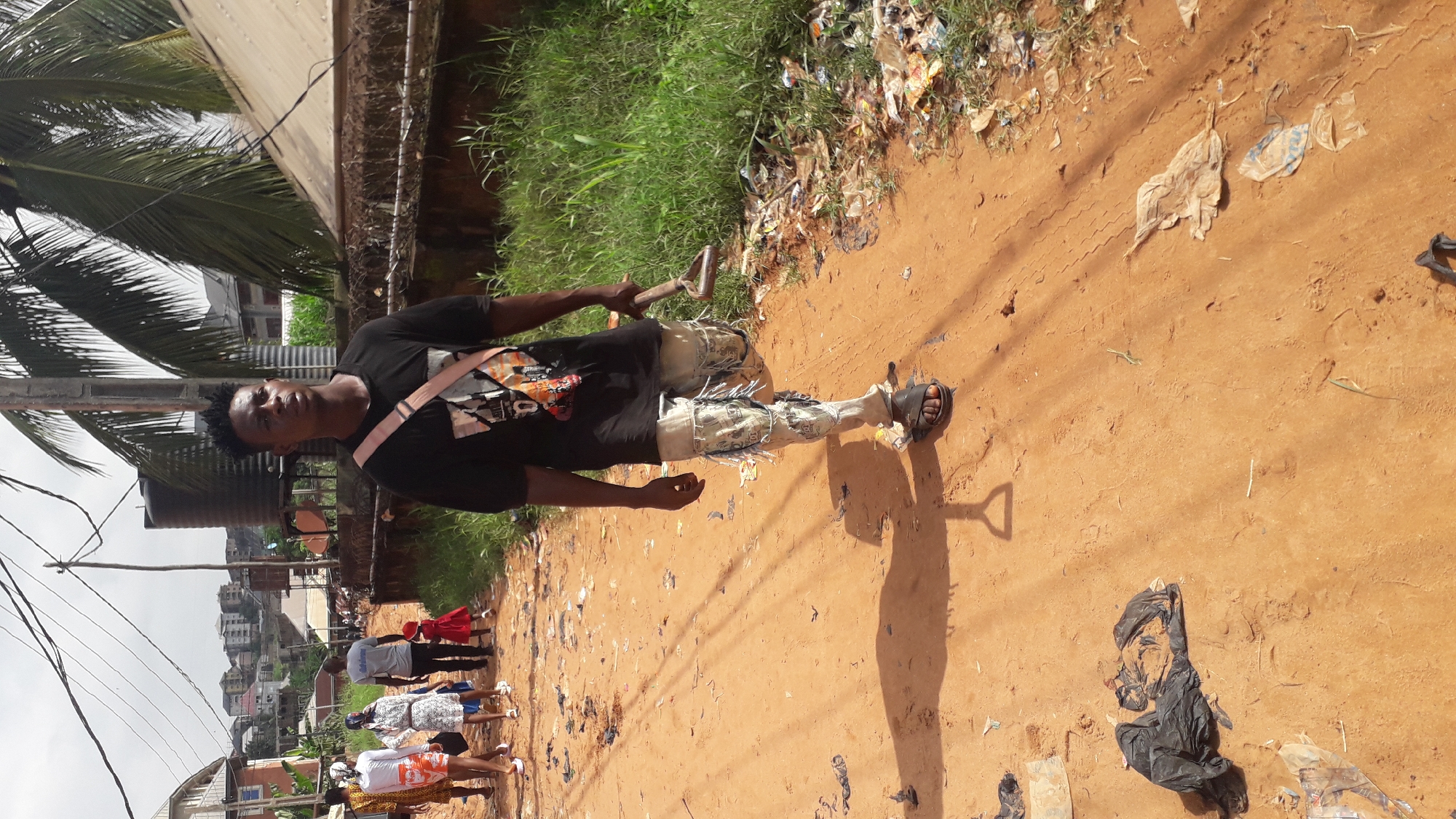 Morning street life along a dirt road in Nkpor, Nigeria