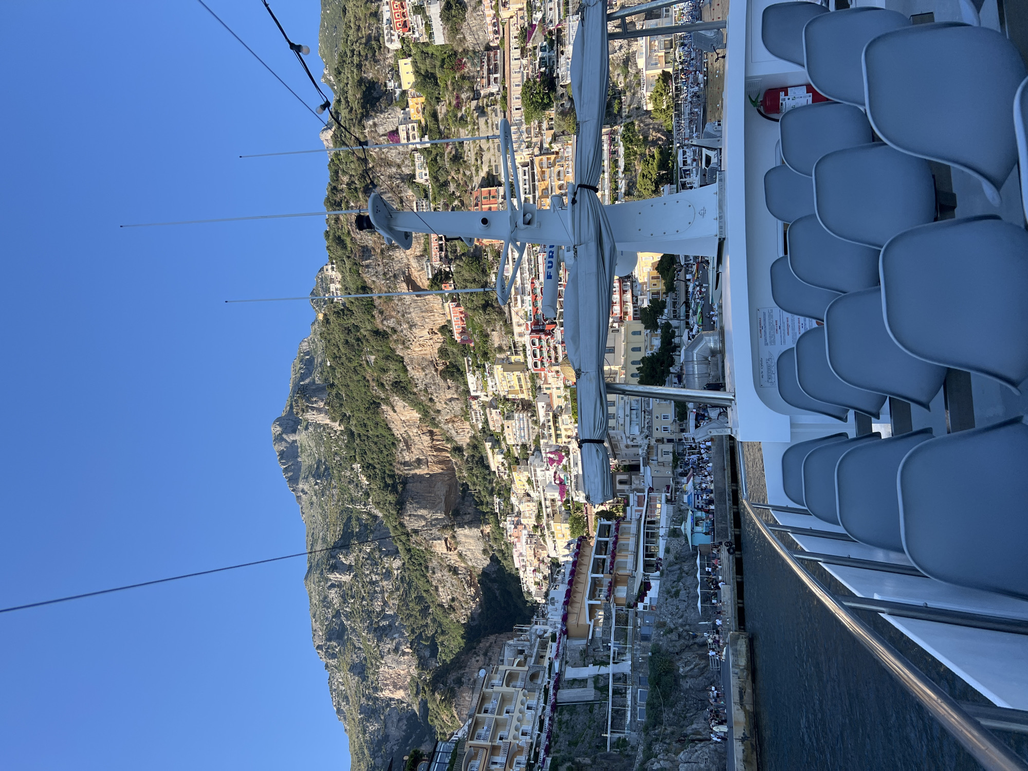 Tourist boat passengers document scenic Arienzo coastline views
