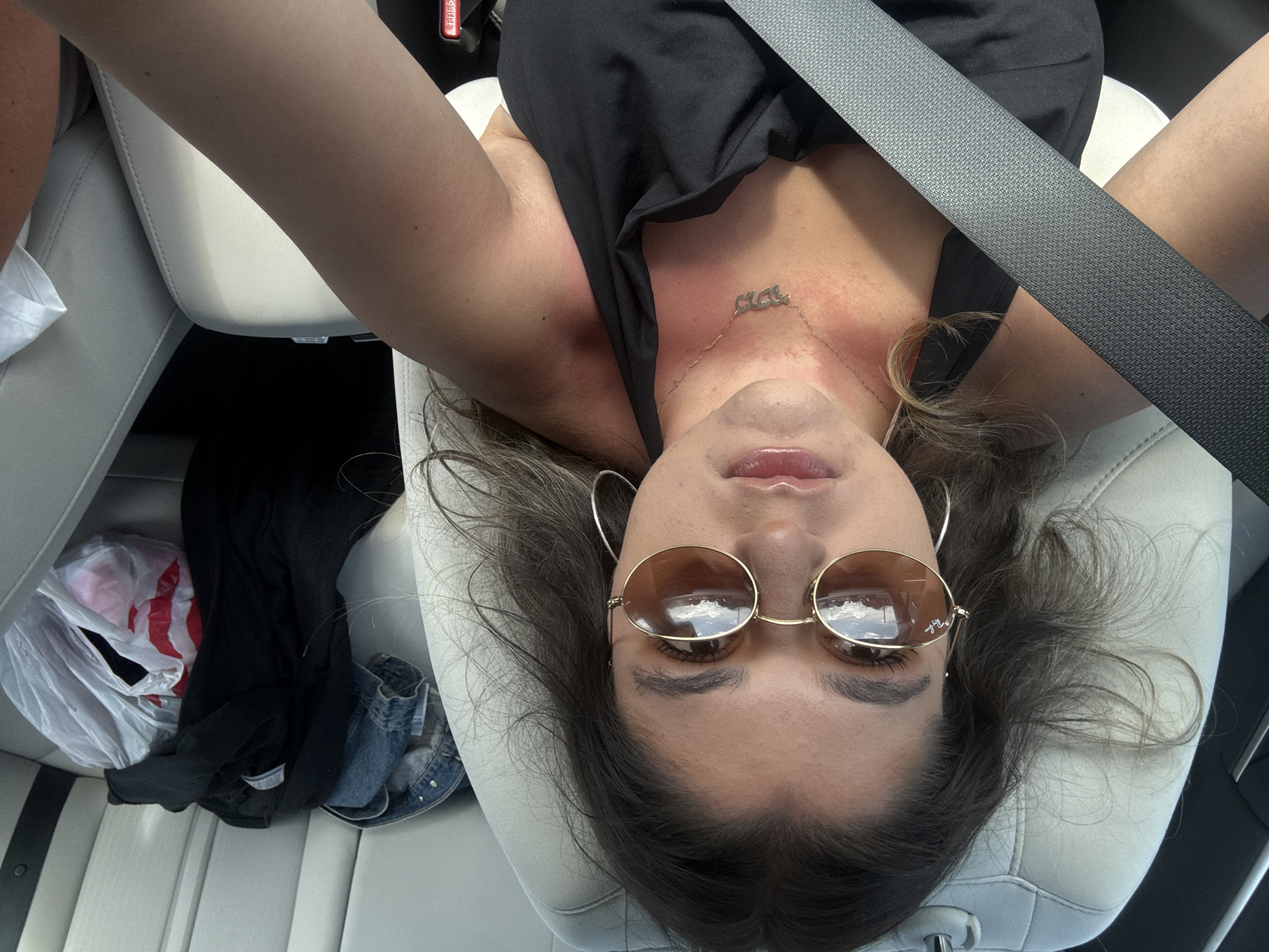 Woman relaxes in car in Hallandale Beach