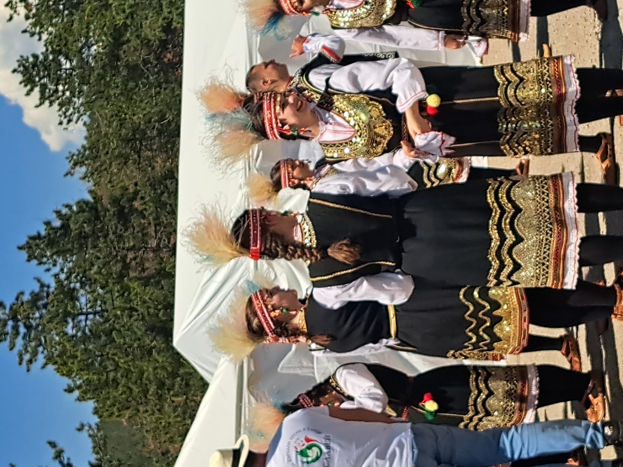 Bulgarian folk dancers perform traditional dance on outdoor stage