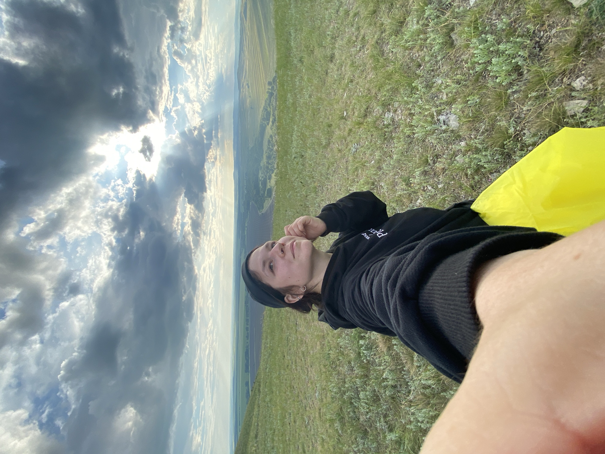 Woman documents afternoon photo session on Russian hillside