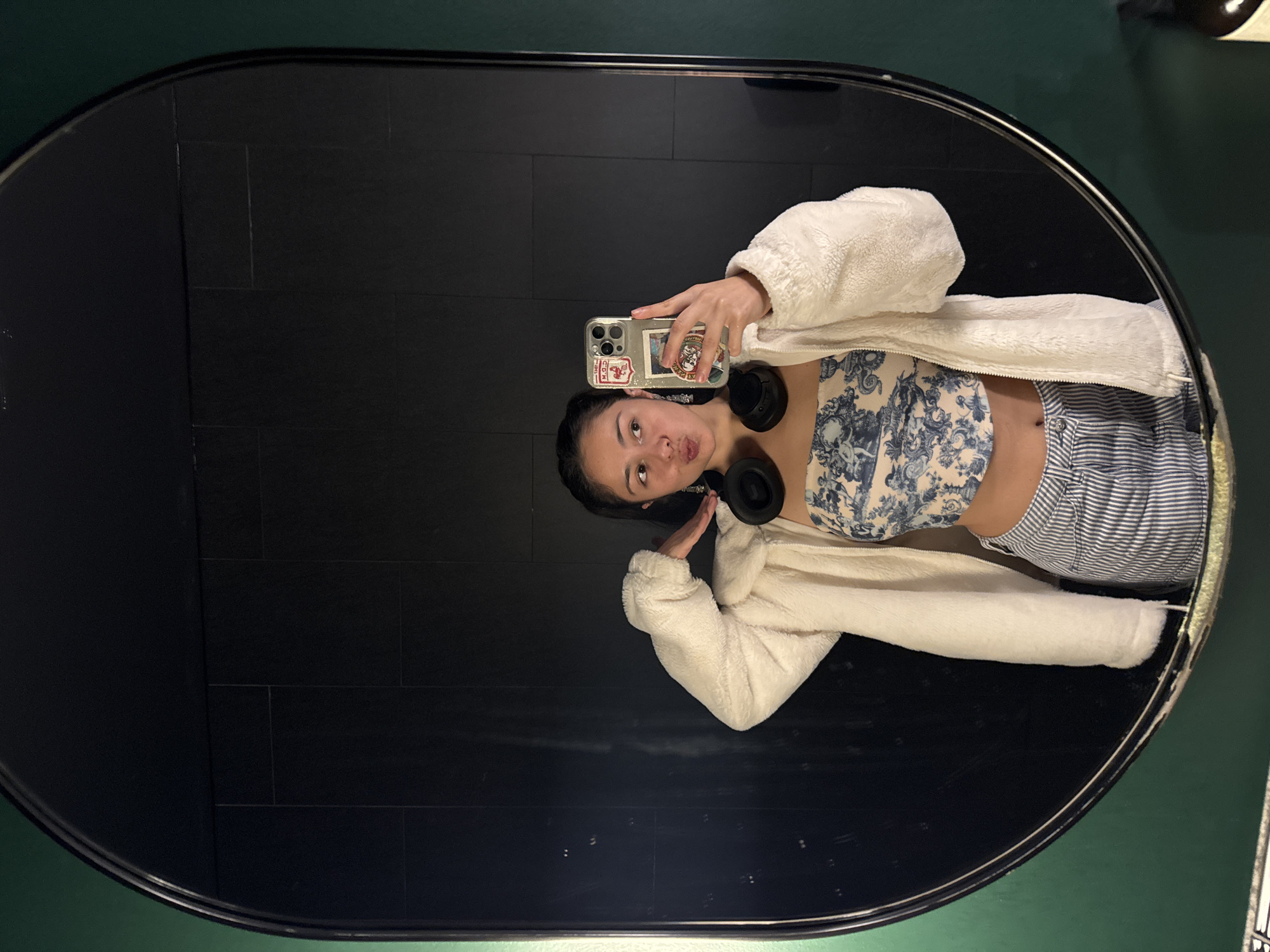 Person takes multiple mirror selfies in decorated Perth building