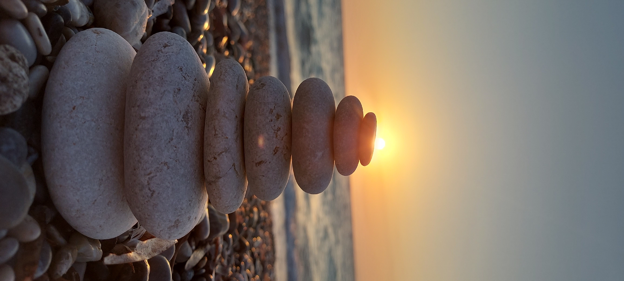 Seven smooth pebbles stacked in balance, Rhodes, Greece