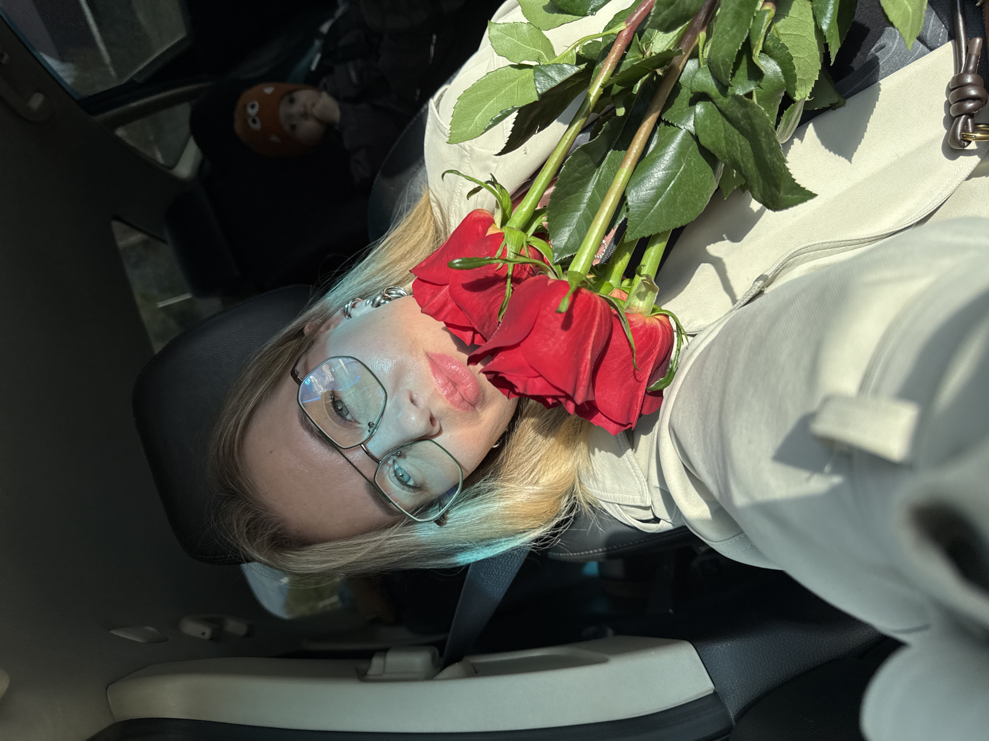 Woman takes selfie with red roses in Chaikovsky