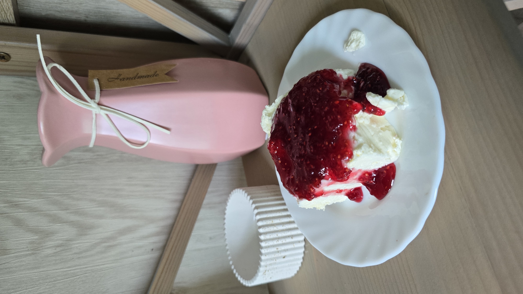 Cream cake with raspberry jam on a wooden table, Kyiv