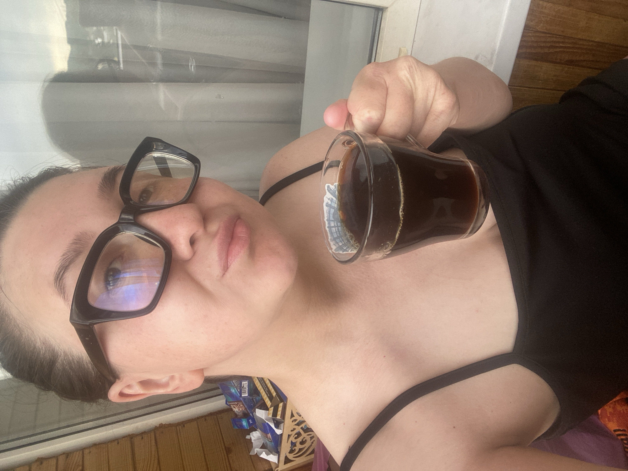 Woman enjoys morning coffee amid cloudy skies in Chaikovsky