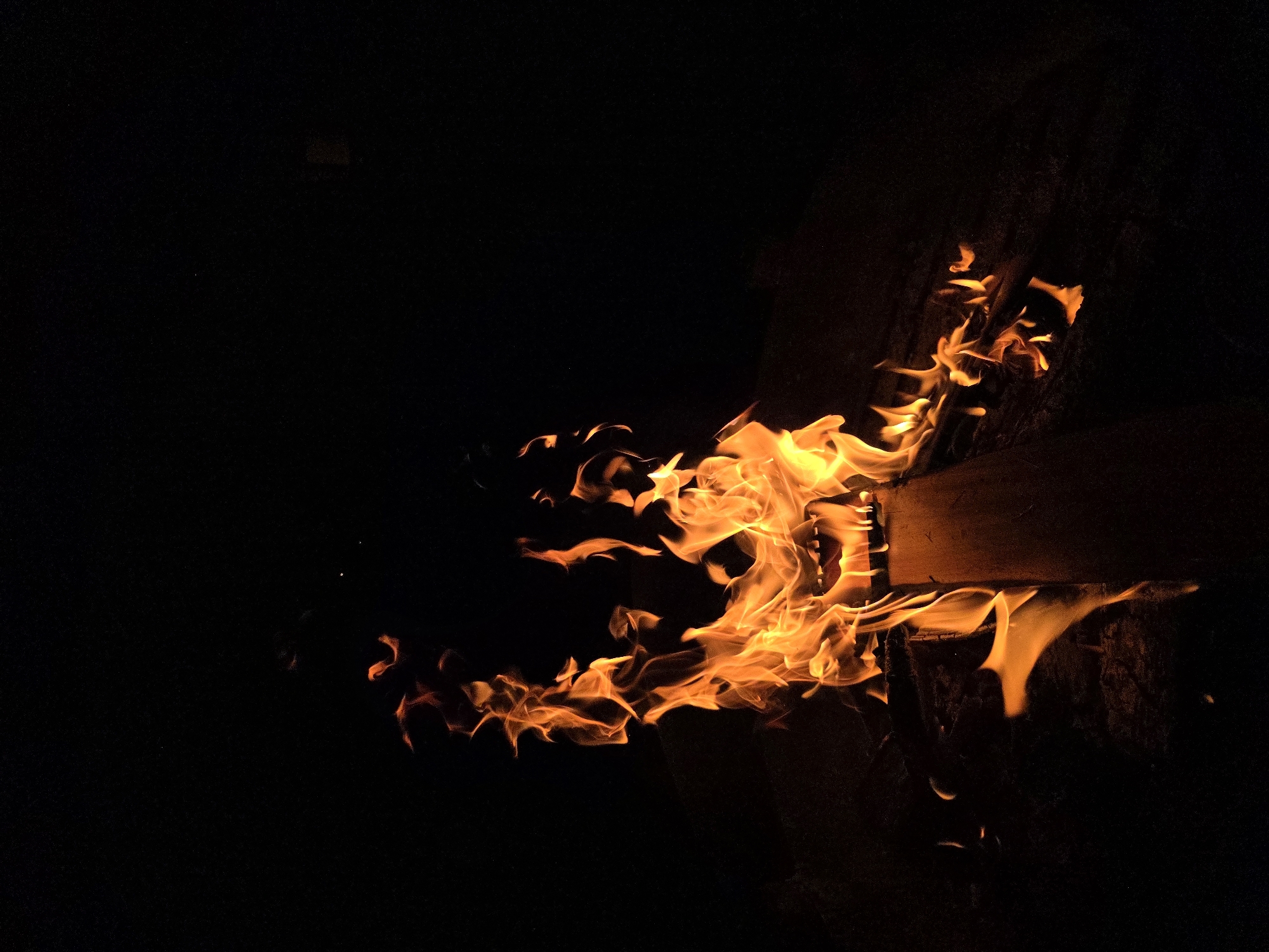 Campfire burning in a metal pit at a Russian dacha settlement
