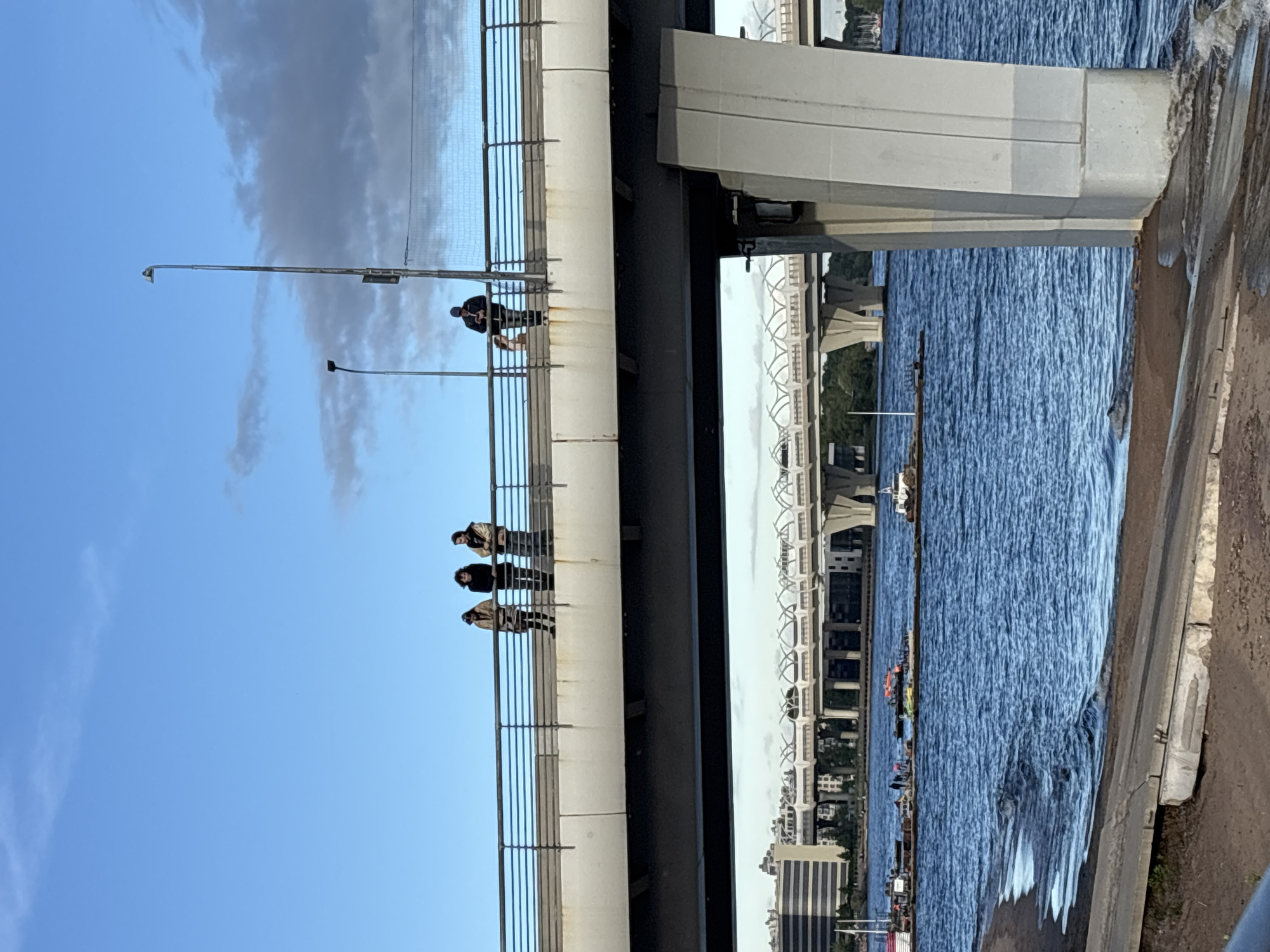 Modern river bridge and waterfront activity in Lednevo, Russia