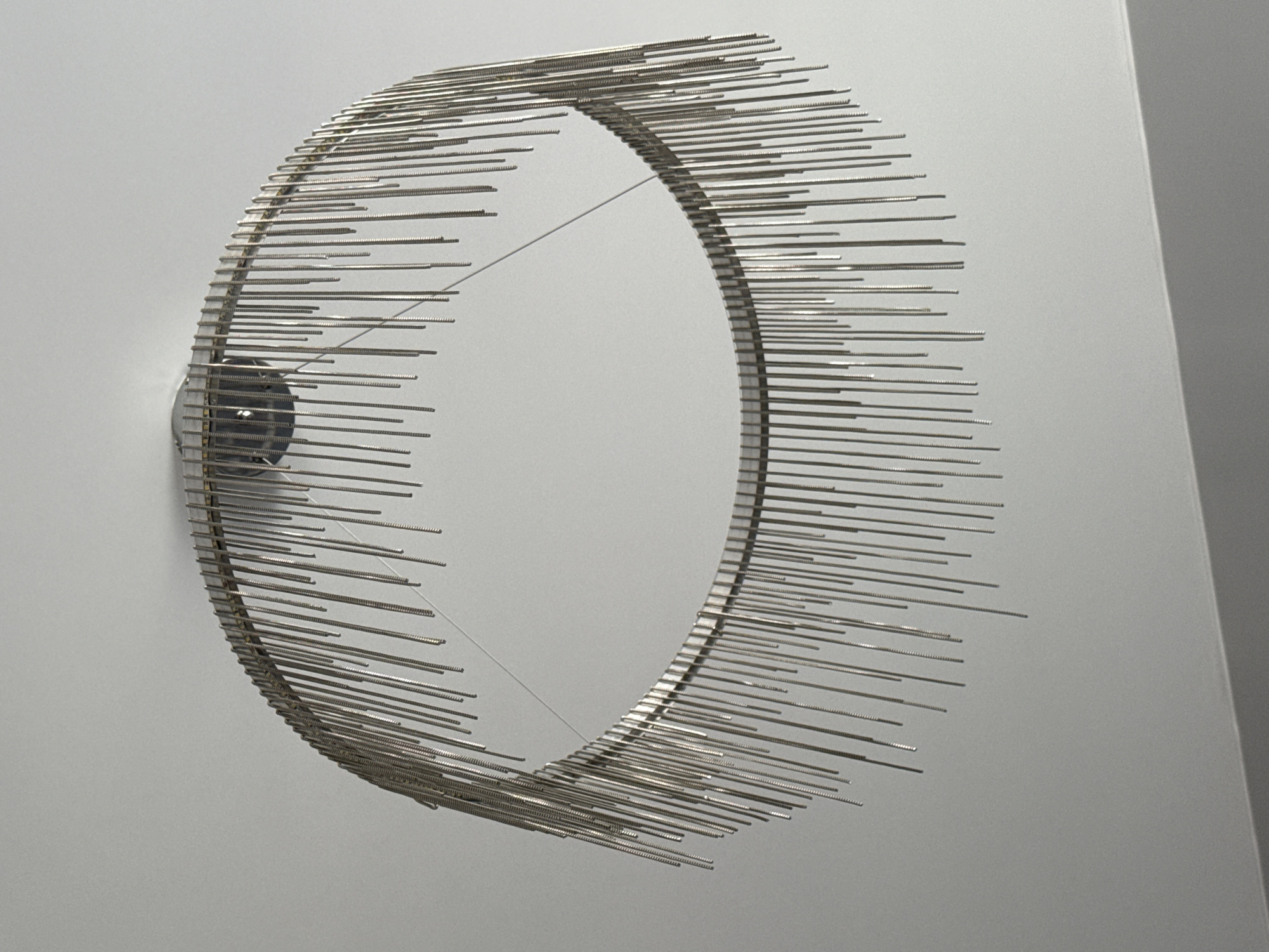 Metal ring sculpture documented on wall in Krasnoyarsk