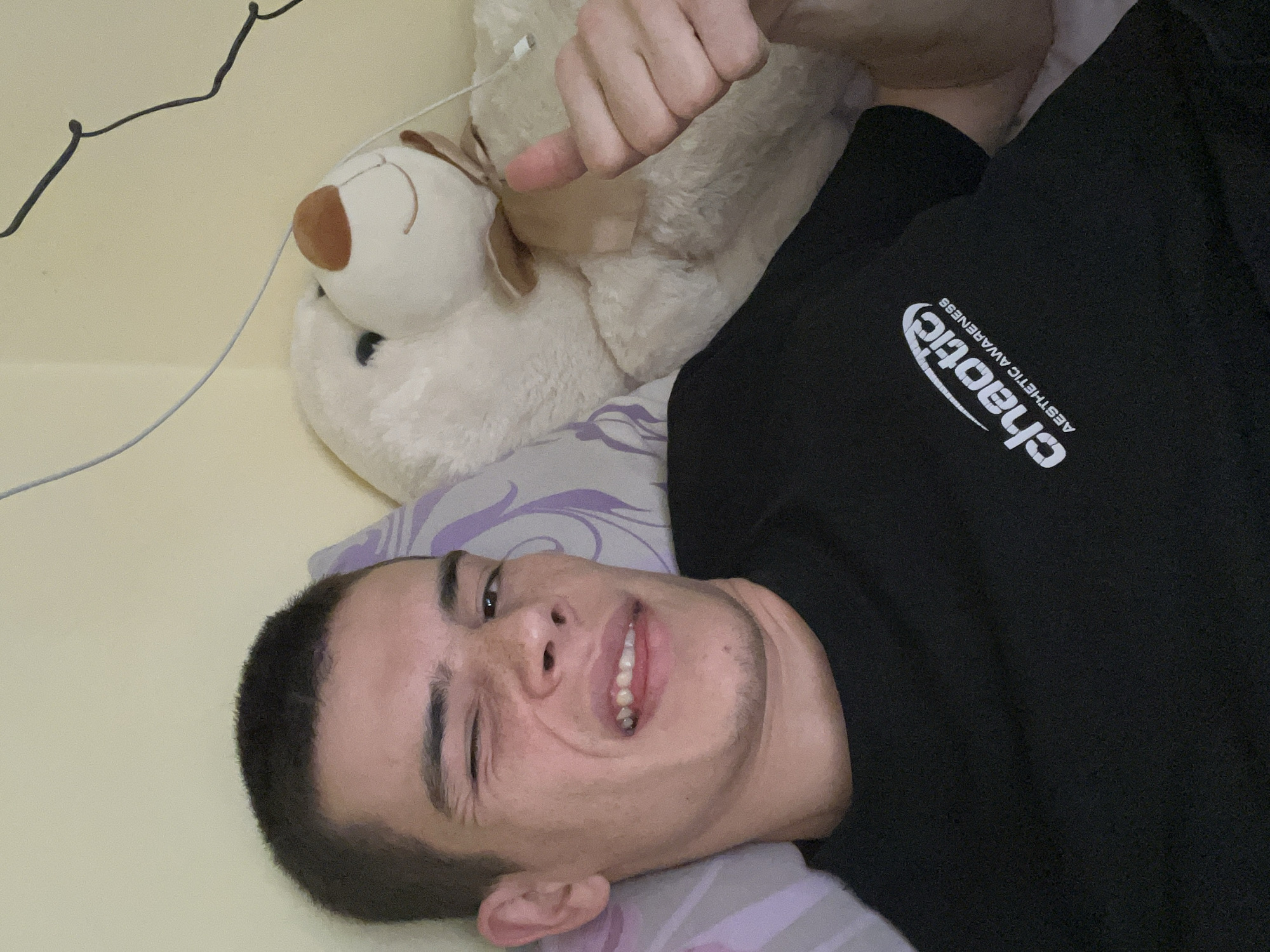 Young man takes selfies with teddy bear in Plovdiv bedroom