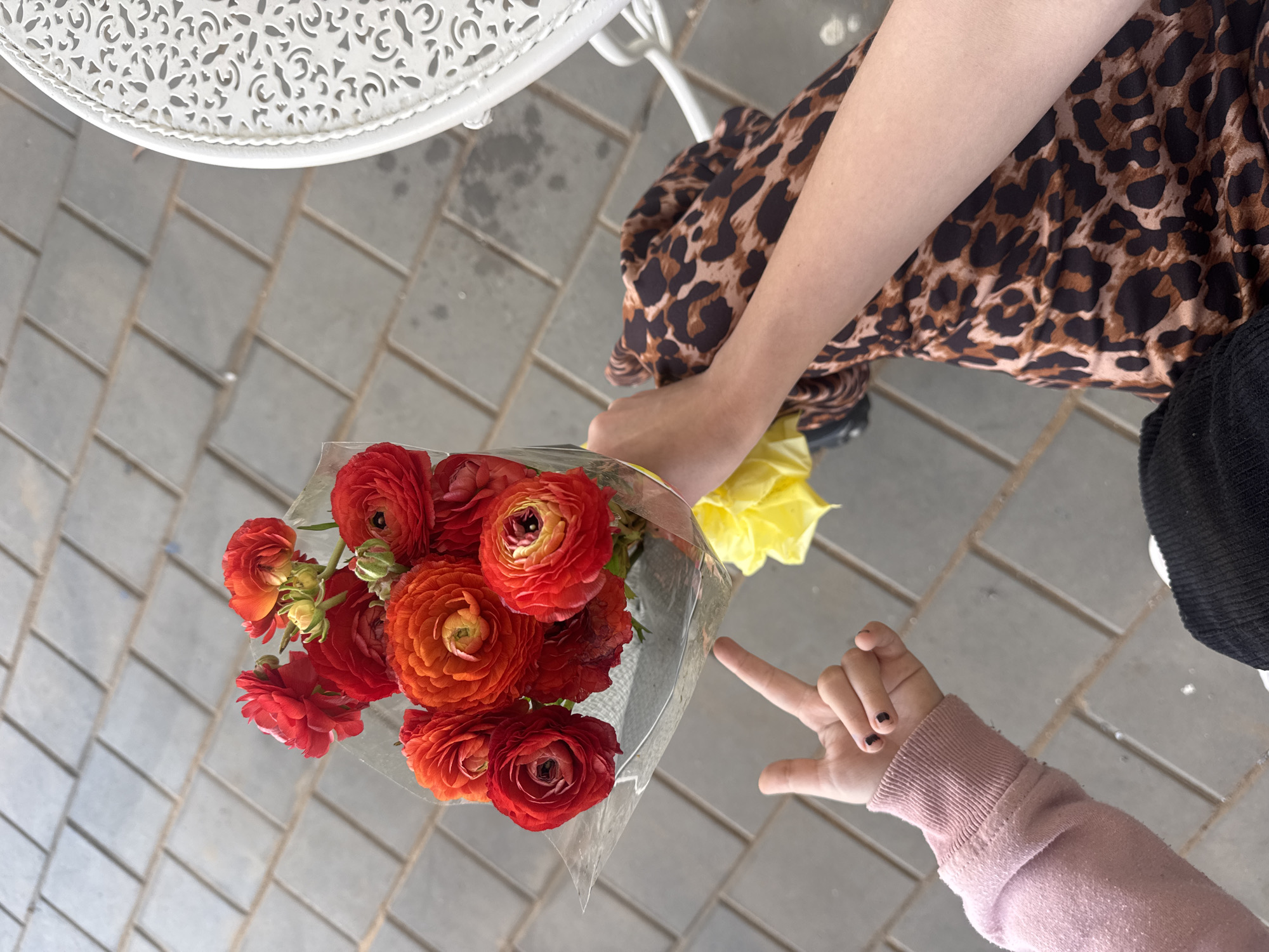 Mother and child share Friday morning flowers in Bat Yam