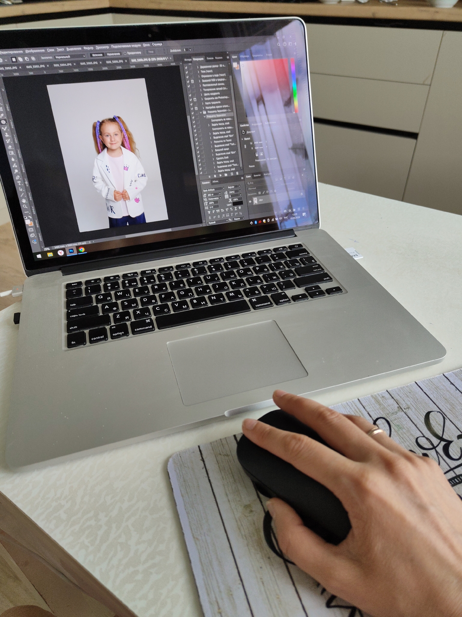 Person uses computer mouse at desk workspace