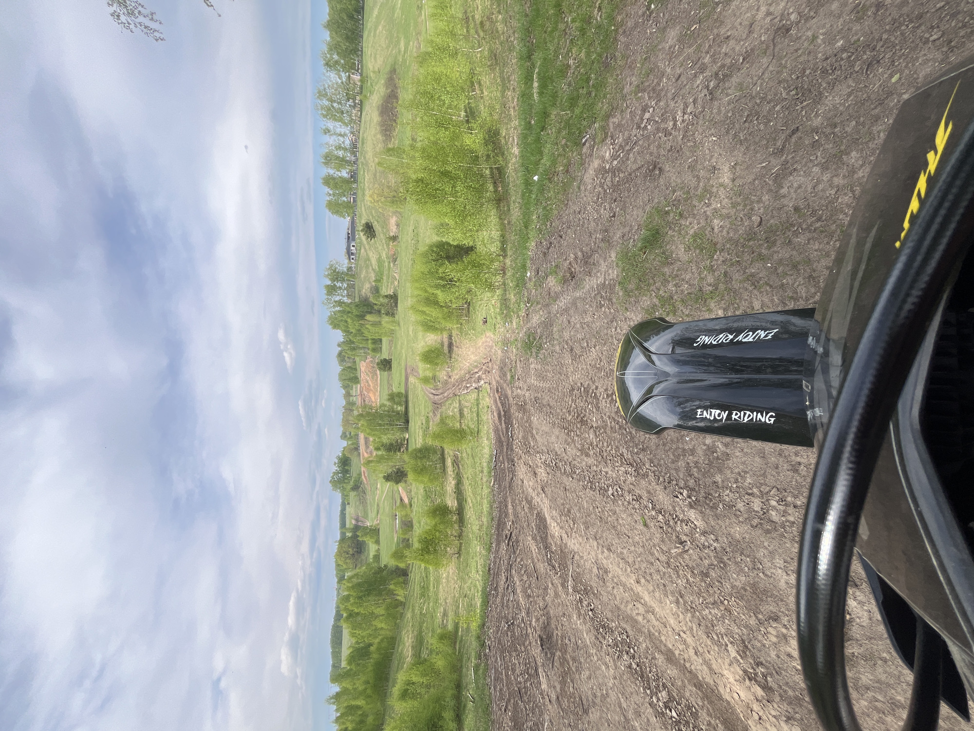Motorcyclist rides dirt track in rural Russia