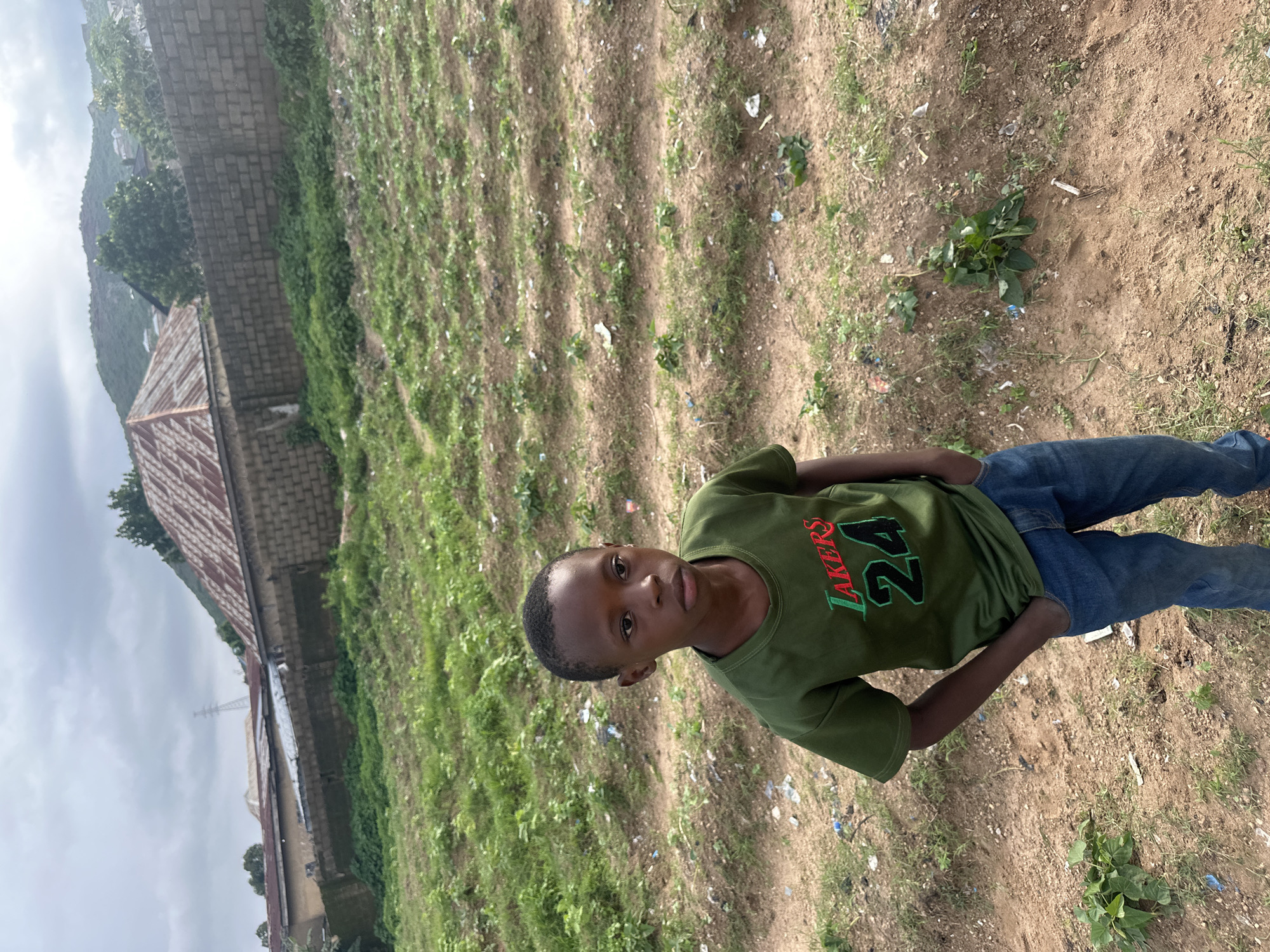 Kids and pickup soccer on a dusty Rukuba Road field