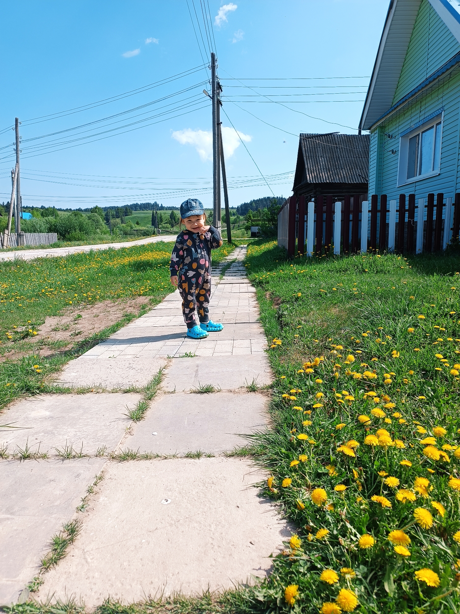 Child explores village surroundings in rural Russia morning