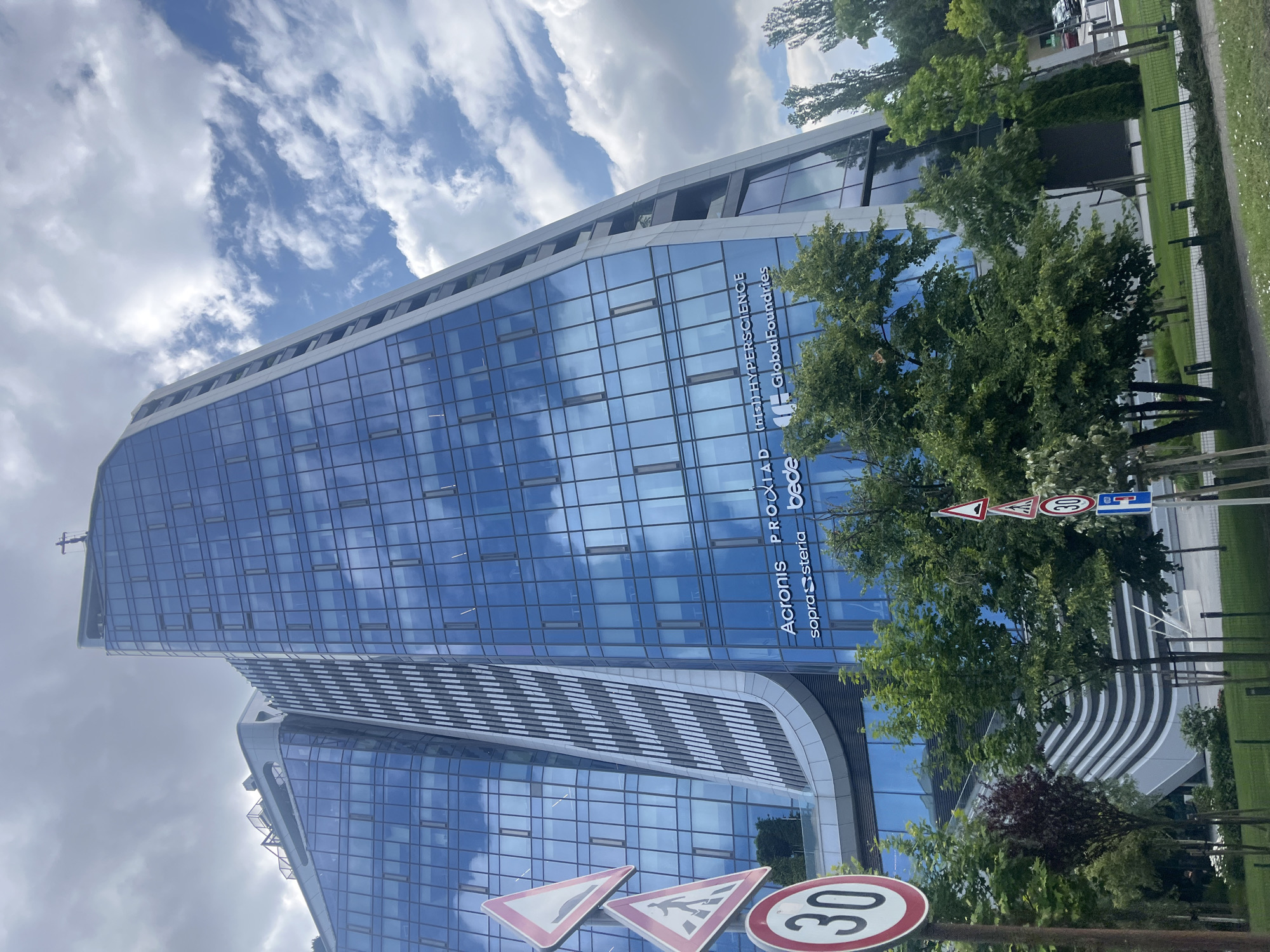 Hotel Vega Sofia's curved glass facade from two angles