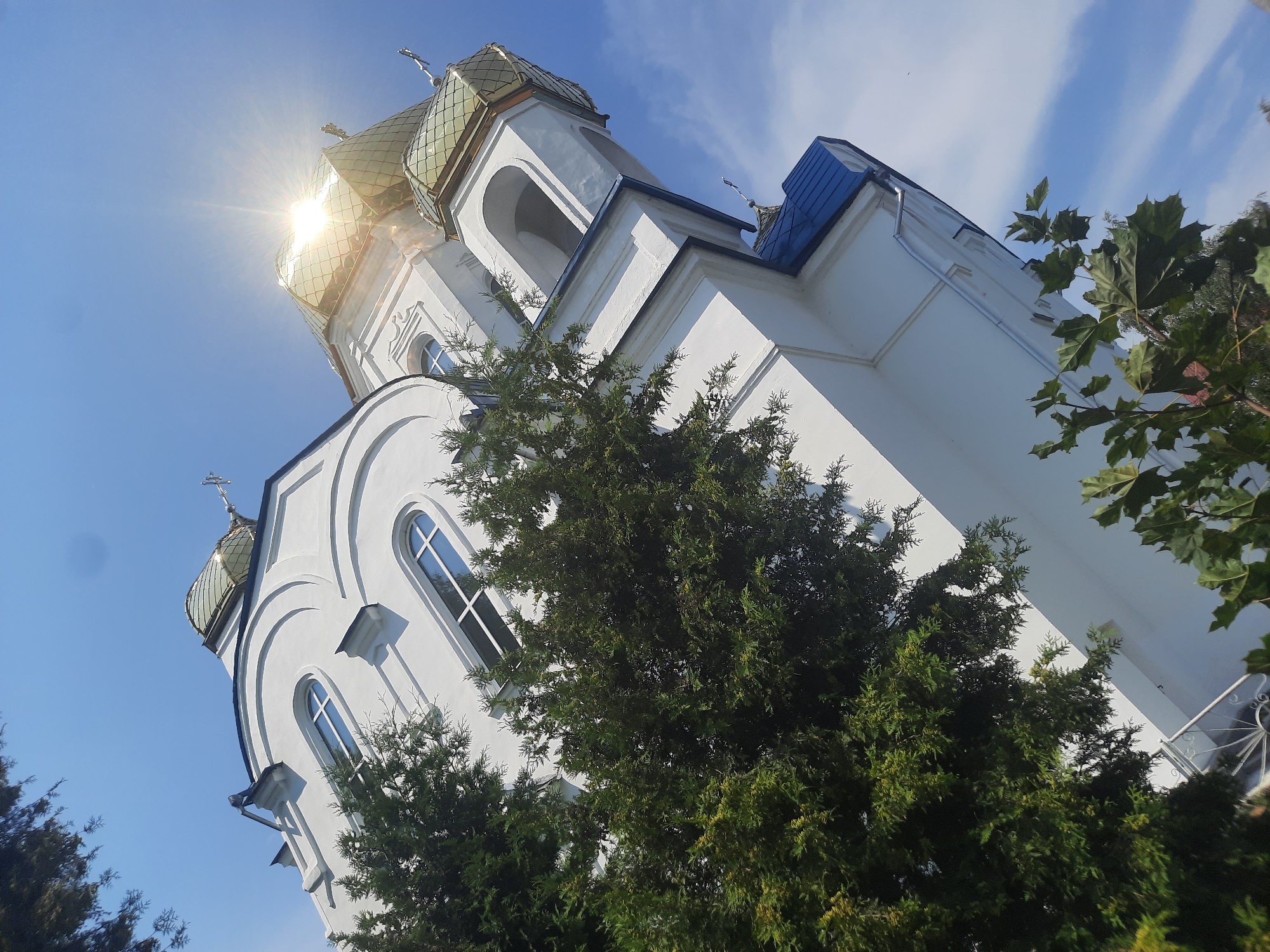Flowers and golden domes at a Shklov Orthodox church