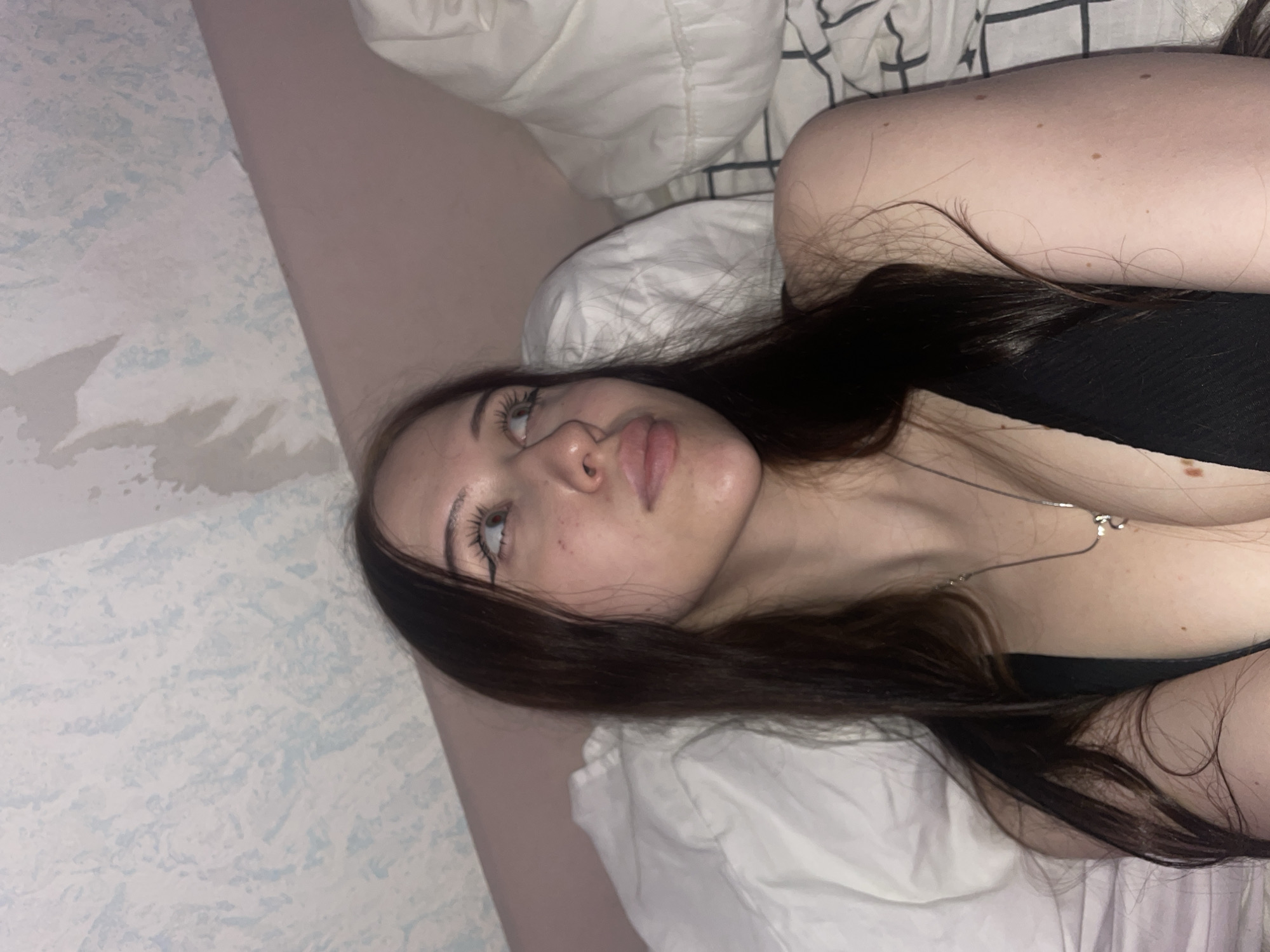 Woman photographed in bedroom with colored lighting in Votkinsk
