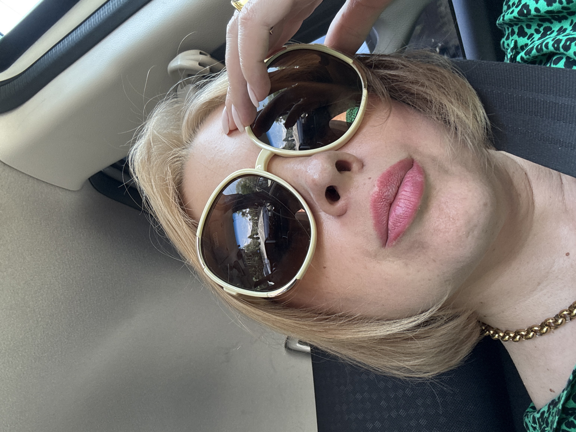 Car selfie in Sochi, sunglasses reflecting sky and trees