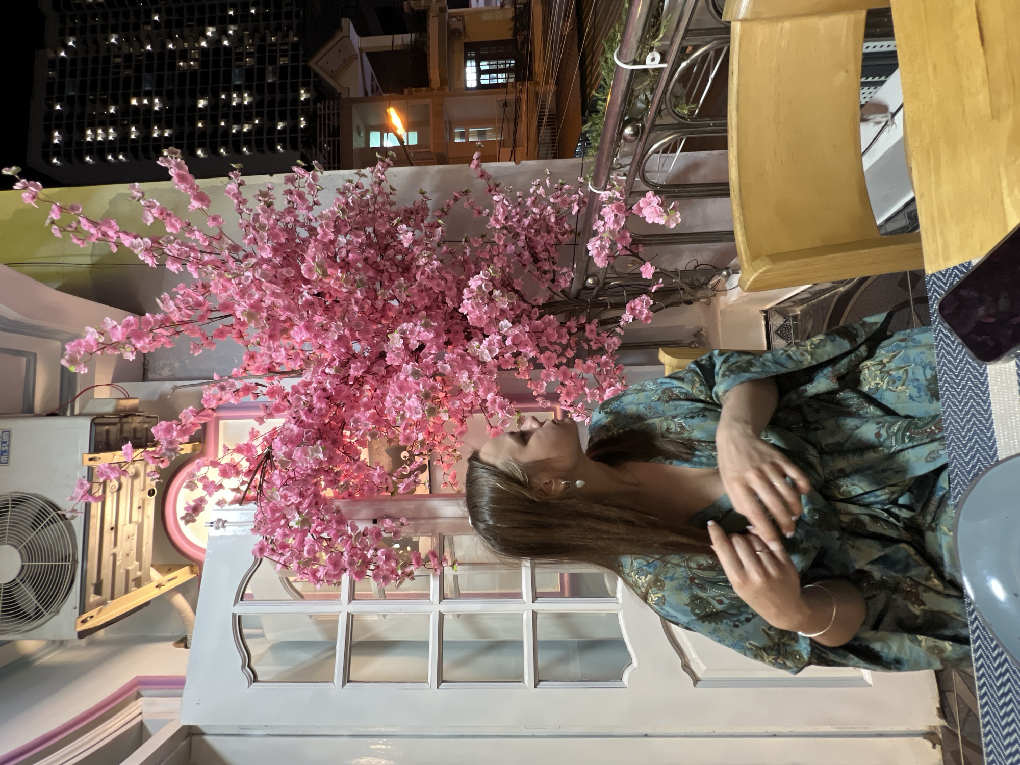 Nighttime outdoor gathering with street life in the background