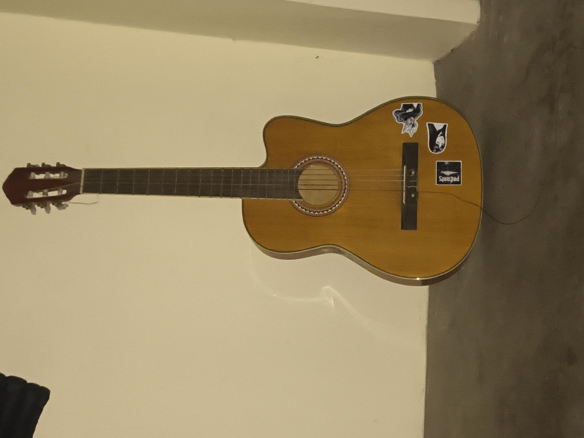 Acoustic guitar session in a Haini bedroom during a rainy morning