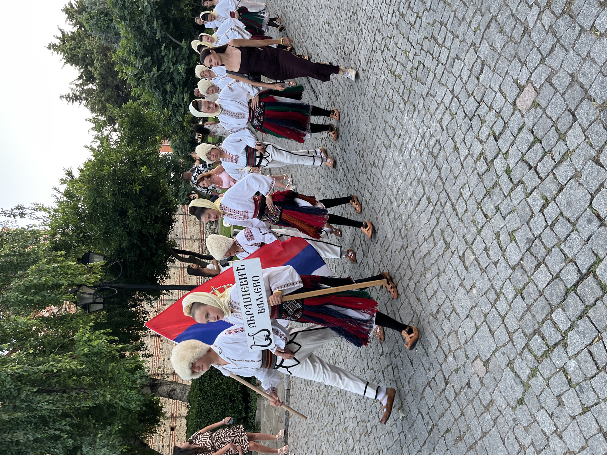 Folk procession and evening crowds fill Nesebar's old town streets