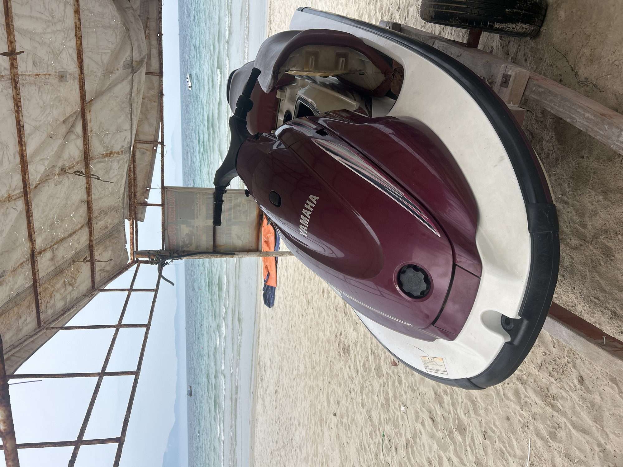 Jet skis parked under canopy on a quiet Vietnamese beach