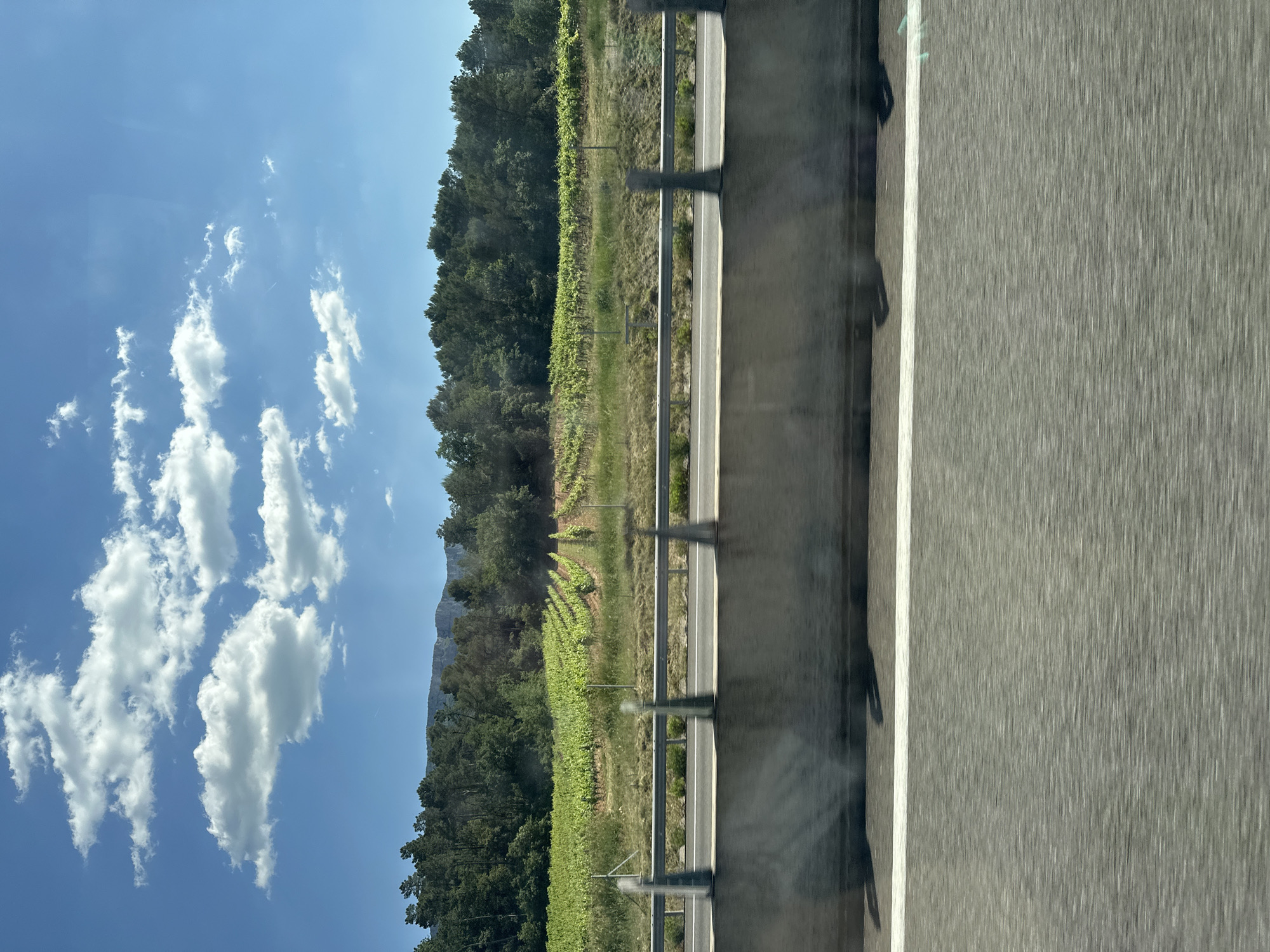 Passenger sleeps during highway journey through Pourcieux, France