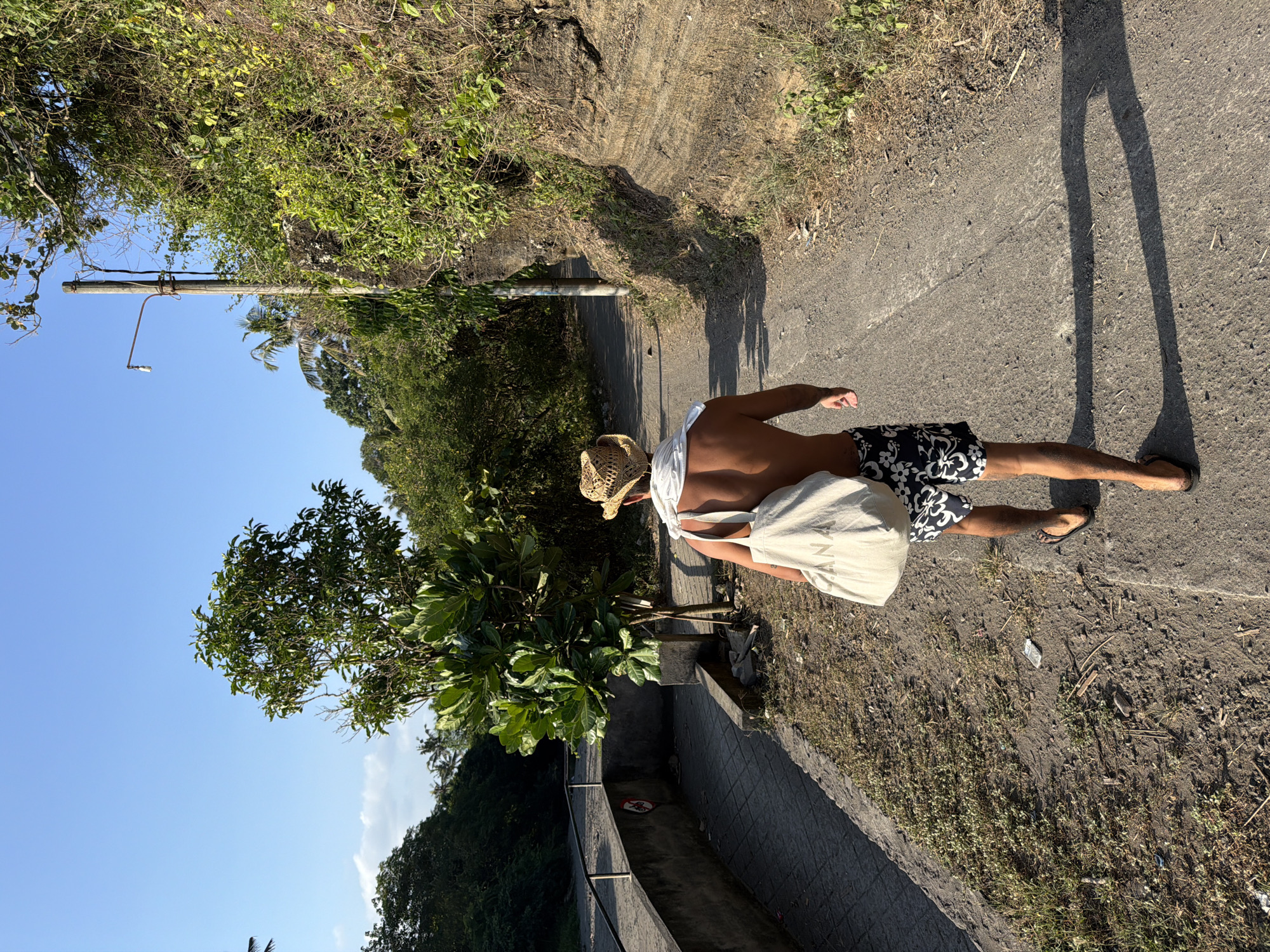 Morning beach walk along Bali's dark sand coast near Kediri