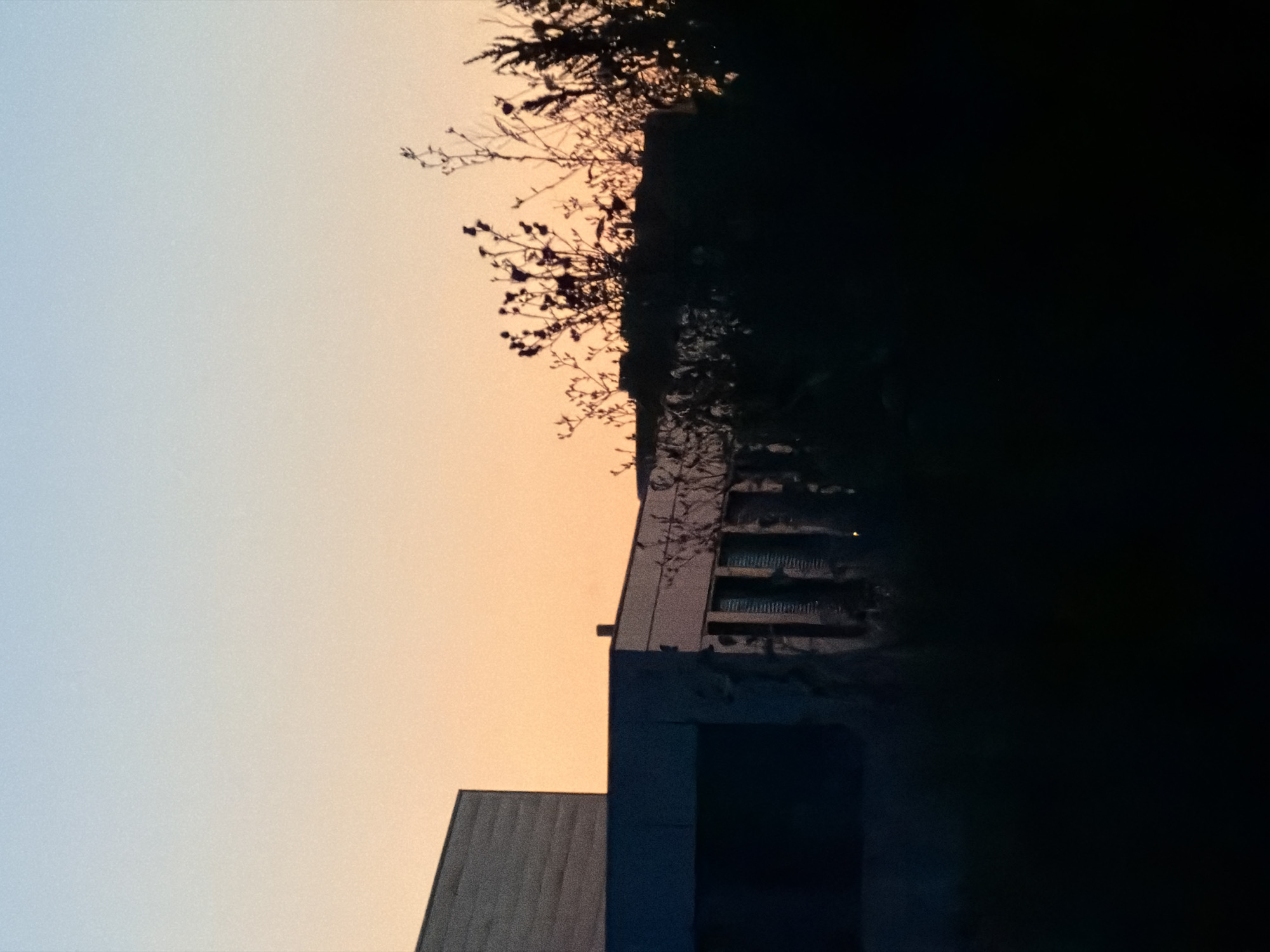 Illuminated modern building against a twilight sky in Leudelange
